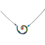 The Firefly Jewelry Spiral Sunburst Multi-Color Necklace is handmade in Guatemala, showcasing a vibrant pendant with blue, pink, green accents and an orange-yellow flower motif. Its colorful design elegantly hangs on a delicate silver chain.