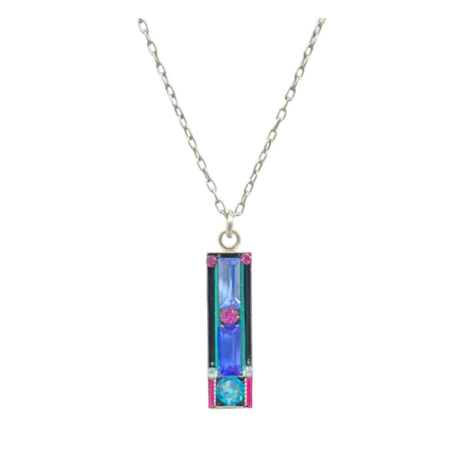 The Firefly Architectural Light Turquoise Necklace features a silver chain with a vertical rectangular pendant adorned with multicolored, iridescent blue, pink, and teal stones. Handmade in Guatemala, its hypo-allergenic and eye-catching.
