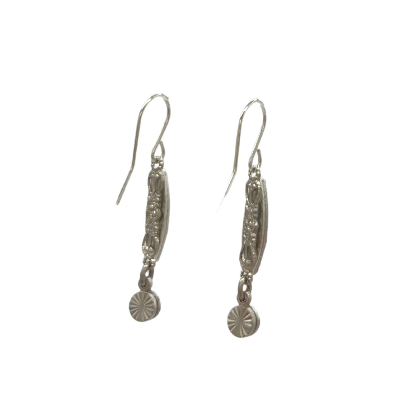 These exquisite Linear Two Tier Multi-Color Earrings by Firefly, handmade in Guatemala, showcase an intricate cylindrical design with decorative patterns and a small charm. Crafted with care against a plain white backdrop, they embody fair-trade practices.