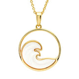 This Gold Vermeil Mother of Pearl Ocean Wave Necklace from Shanore showcases a circular wave design in white enamel, encased in a thin gold circle, and elegantly hangs from a delicate gold chain.