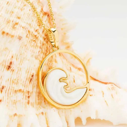 Shanores Gold Vermeil Mother of Pearl Ocean Wave necklace features a gold vermeil chain with a circular pendant, displaying an ocean wave design against a beige shell background.