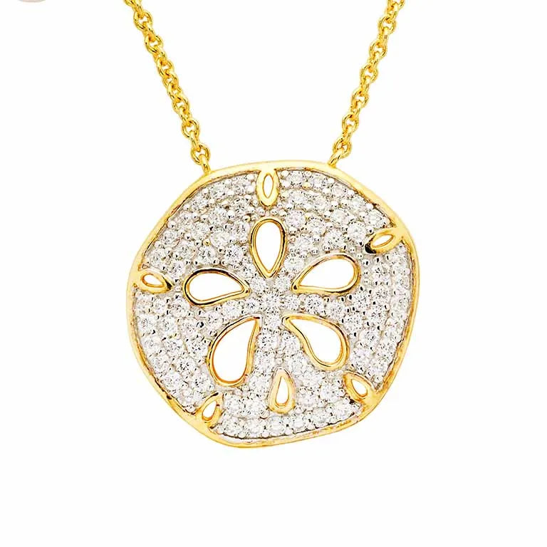 The Shanore Gold Vermeil Sand Dollar Necklace, from the Ocean Jewelry collection, showcases a sand dollar-shaped pendant with glittering cubic zirconia. This intricately designed piece has a cut-out texture and hangs elegantly on a delicate chain.