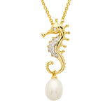 The Shanore Gold Vermeil Pearl Seahorse Necklace from Ocean Jewelry features a seahorse pendant embellished with cubic zirconia and a white pearl, elegantly hanging from a delicate gold chain for a luxurious and stylish look.