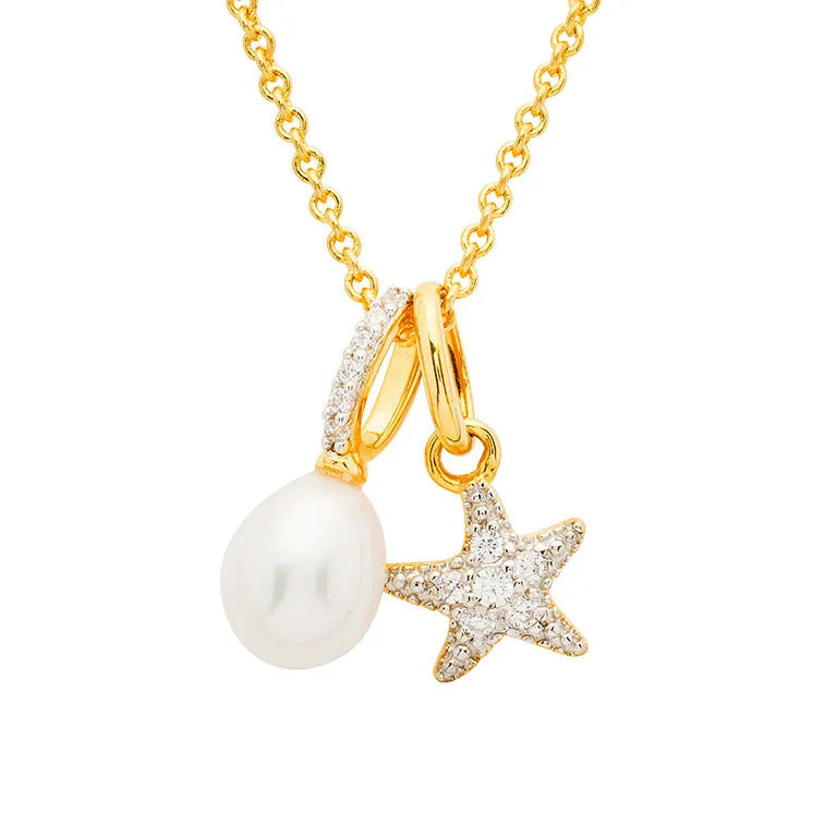 The Shanore Gold Vermeil Starfish and Pearl Necklace features a white pearl pendant and a zirconia-adorned starfish on a delicate chain, offering an elegant ocean-inspired design.