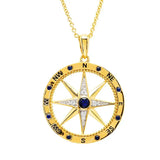 The Shanore Gold Vermeil Blue Sapphire Compass Necklace from Ocean Jewelry features a 14k gold vermeil design with a compass rose pendant adorned with a lab-grown sapphire center and delicate accents. Cardinal directions, elegantly marked in black, hang on a shimmering gold chain.