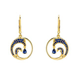 These stunning Gold Vermeil Blue Sapphire Wave Earrings by Shanore, from the Ocean Jewelry collection, showcase lab-grown blue sapphires set in 14k gold vermeil for a perfect blend of elegance and modern sophistication.