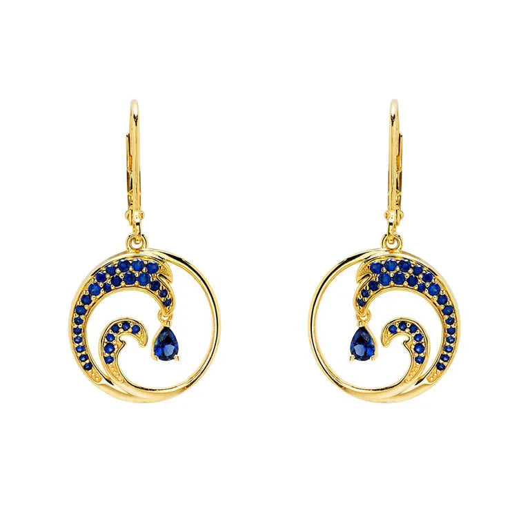 These stunning Gold Vermeil Blue Sapphire Wave Earrings by Shanore, from the Ocean Jewelry collection, showcase lab-grown blue sapphires set in 14k gold vermeil for a perfect blend of elegance and modern sophistication.