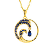 The Shanore Gold Vermeil Blue Sapphire Wave Necklace features a stylized wave pendant with lab-grown sapphires and a teardrop-shaped gem at its center, embodying ocean jewelry. The delicate chain enhances its stunning design.