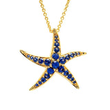 Introducing Shanore’s Gold Vermeil Blue Sapphire Starfish Necklace from Ocean Jewelry: a beach-inspired piece with a gold chain and starfish-shaped pendant adorned with vibrant blue lab-grown sapphires accentuating each of its five limbs.