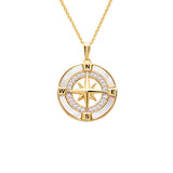 The Gold Vermeil Mother of Pearl Compass Necklace by Shanore features a star at its center, surrounded by N, S, E, and W markers. Small white stones elegantly embellish the circular border against a mother of pearl backdrop.