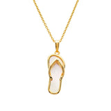 The Shanore Gold Vermeil Mother of Pearl Flip Flop Necklace, from Ocean Jewelry, showcases a striking mother of pearl inlay on a flip-flop shaped pendant. The simple and elegant chain lies against a plain white background.