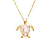 The Gold Vermeil Mother of Pearl Turtle Necklace from Shanore showcases an intricately designed pendant with a detailed shell and white inlay, echoing the charm of ocean treasures.