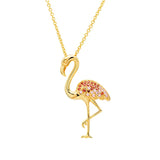 The Shanore Gold Vermeil Pink Flamingo Necklace from Ocean Jewelry features a charming flamingo pendant adorned with red and pink gemstones on its wings and body, standing elegantly on one raised leg against a pristine white background.