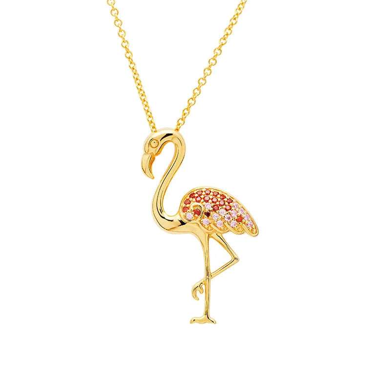 The Shanore Gold Vermeil Pink Flamingo Necklace from Ocean Jewelry features a charming flamingo pendant adorned with red and pink gemstones on its wings and body, standing elegantly on one raised leg against a pristine white background.