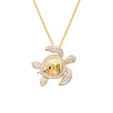 The Gold Vermeil Shell Turtle Necklace by Shanore boasts a 14k gold vermeil body with cubic zirconia-adorned limbs. This elegant ocean jewelry piece hangs from a fine gold chain, blending sophistication and charm.