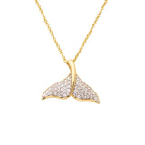The Shanore Gold Vermeil Whale Tail Necklace from Ocean Jewelry features a whale tail pendant adorned with sparkling cubic zirconia, elegantly crafted in a smooth, curved design and hanging from a delicate gold chain.