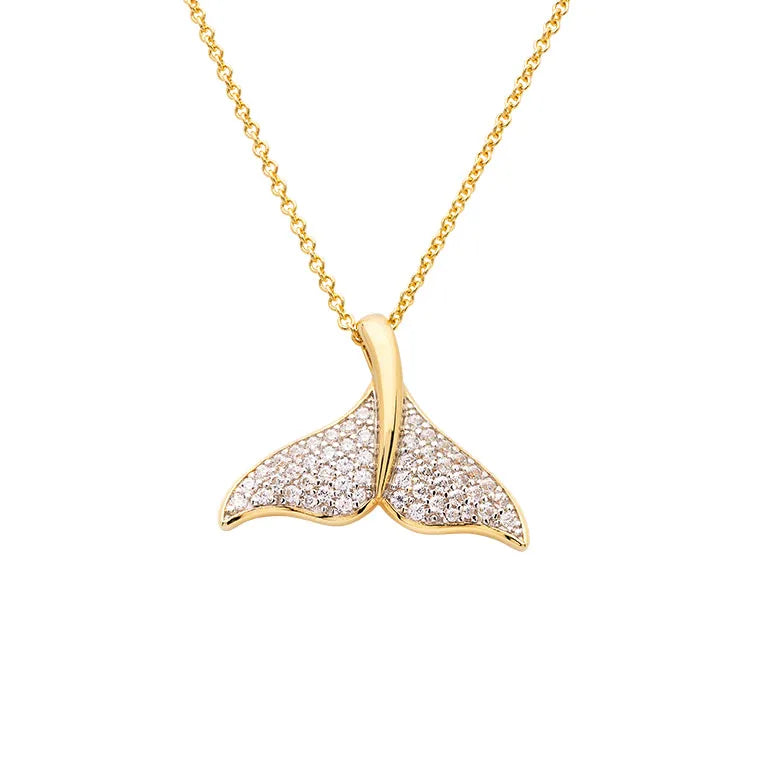 The Shanore Gold Vermeil Whale Tail Necklace from Ocean Jewelry features a whale tail pendant adorned with sparkling cubic zirconia, elegantly crafted in a smooth, curved design and hanging from a delicate gold chain.