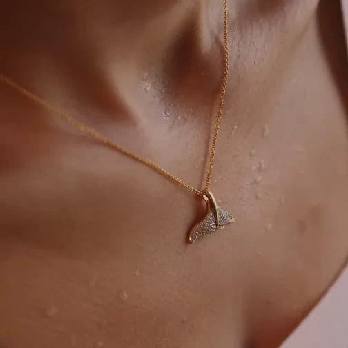Close-up of a neck and upper chest, featuring Shanores Gold Vermeil Whale Tail Necklace - Ocean Jewelry. The skin glistens with water droplets, suggesting a fresh or dewy look.
