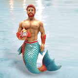 The December Diamonds Clown Fish Ornament is a stunning merman figurine with red hair and beard, holding a clownfish. It features a muscular torso, blue and red-scaled tail, arm bands, and a decorative belt against a light blue water surface—ideal for holiday decor.