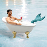 The Mr Bubbles Ornament by December Diamonds features a bearded merman lounging in a bubble-filled clawfoot tub, holding red wine. His turquoise tail and necklace complement this whimsical holiday decor.