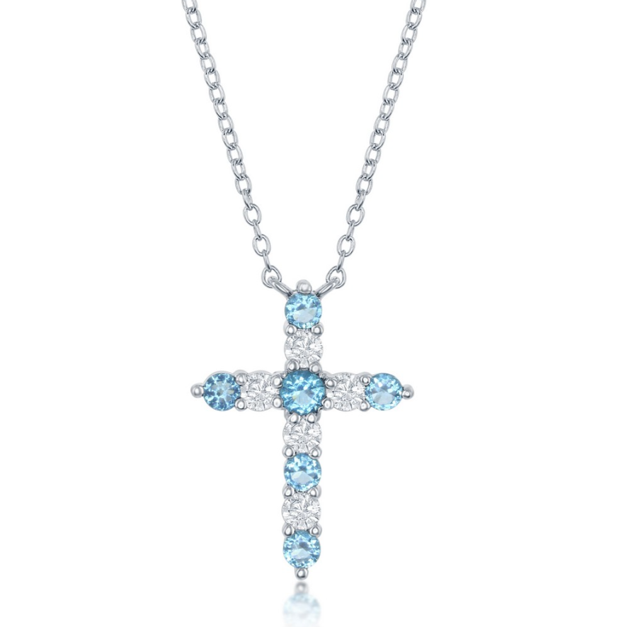 The Classic of New York NK: SS Birthstone Cross December w/chain features a sterling silver cross pendant with alternating Swiss Blue CZ and clear stones—an elegant December birthstone necklace.