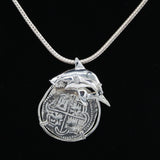 Explore The Treasure Shoppe Inc.’s 8 Reale Shark Coin: a stunning silver pendant featuring a shark design around an ancient coin, set in sterling silver. The engraved coin hangs elegantly, offering timeless elegance.