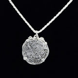 The Treasure Shoppe Inc.s Large Octopus Coin-Atocha Shipwreck Pendant is set in a detailed sterling silver bezel, evoking historical Atocha coins, displayed on a twisted silver chain against a black background to highlight its intricate design.
