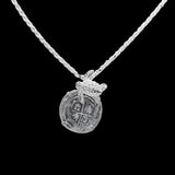 The Treasure Shoppe Inc. offers the Silver Medium Turtle Coin pendant, reminiscent of Atocha shipwreck coins, featuring a cross design and encased in a sterling silver bezel. Note: This is the pendant only; chain not included.