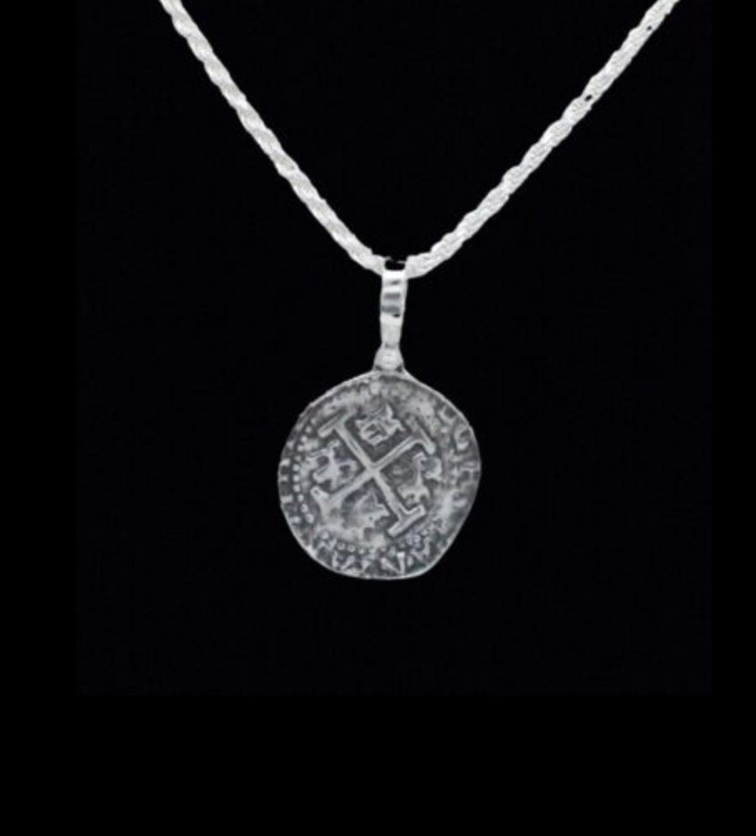 The Treasure Shoppe Inc. offers the Lima 8 Escudo Coin - Atocha Shipwreck Coins pendant only, featuring a sterling silver bezel encasing an ancient coin with intricate engravings and a central cross pattern, reminiscent of treasures from Nuestra Señora de Atocha.