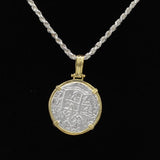 The Treasure Shoppe Inc.s Gold Plated Large Framed Coin features an Atocha Shipwreck coin encased in gold, suspended on a twisted silver chain. This historic coin, with detailed engravings, exudes timeless charm against a black backdrop.