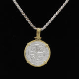 The Treasure Shoppe Inc.s Gold Plated Large Framed Coin Pendant from the Atocha Shipwreck exudes historic charm with its intricate design, elegantly set in a gold bezel. It blends timeless allure with contemporary style when displayed against a black background.