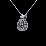 The Medium Antique Octopus Coin from The Treasure Shoppe Inc. is an exquisite sterling silver pendant styled like an Atocha shipwreck coin, where an octopus gracefully encircles the top against a black background, highlighting its intricate design and historical allure.