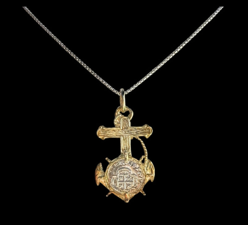 The Treasure Shoppe Inc. offers the Gold Plated Anchor Coin- Atocha Shipwreck Coins pendant, a gold cross, globe, and anchor design framed in sterling silver, perfectly showcased on a thin chain against a black background.