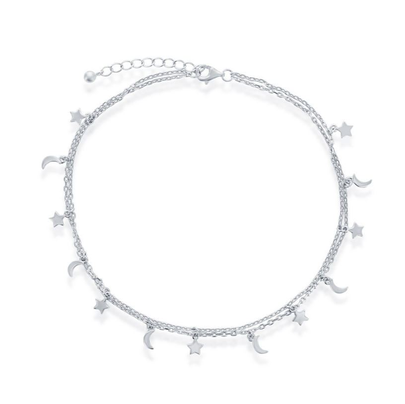 The Classic of New York Sterling Silver Moon & Star Double Strand Anklet features delicate star and crescent moon charms with an adjustable clasp, making it a charming accessory for any occasion.