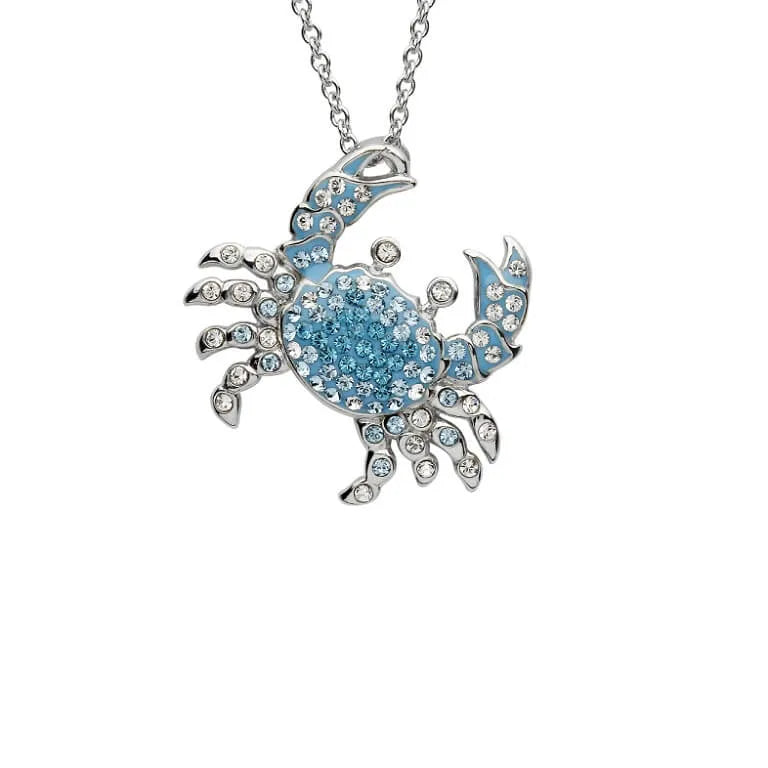 The Shanore Swarovski Crystals Blue Crab Necklace-Ocean Jewelry features a striking crab pendant on a delicate sterling silver chain, adorned with shimmering crystals for captivating marine-inspired elegance.