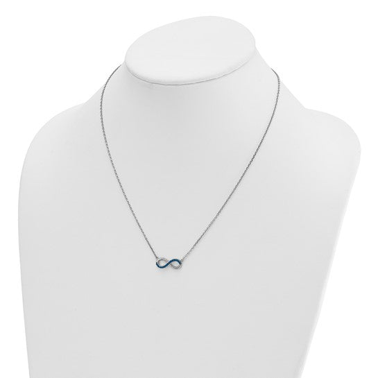 The Presco/Quality Gold Crystal Infinity Necklace features a small blue infinity symbol pendant on a silver chain, elegantly displayed on a white jewelry bust.