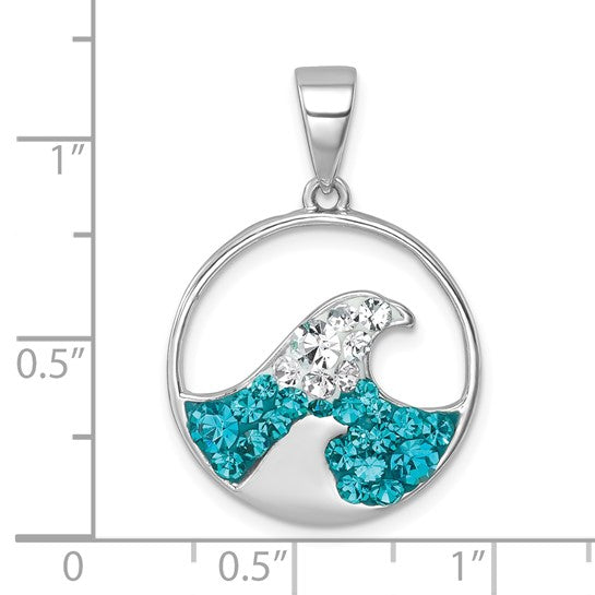 The Presco/Quality Gold Crystal Wave Whitecap Pendant is a round sterling silver piece with blue and white gemstones in a wave design. Shown on an inch grid for scale, this elegant pendant resists tarnish for lasting shine.