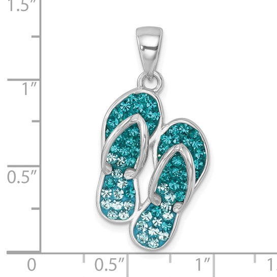 The Presco/Quality Gold Crystal Double Flip Flop Pendant, crafted in sterling silver and embellished with blue and teal crystals, is shown against an inch ruler to display its size.