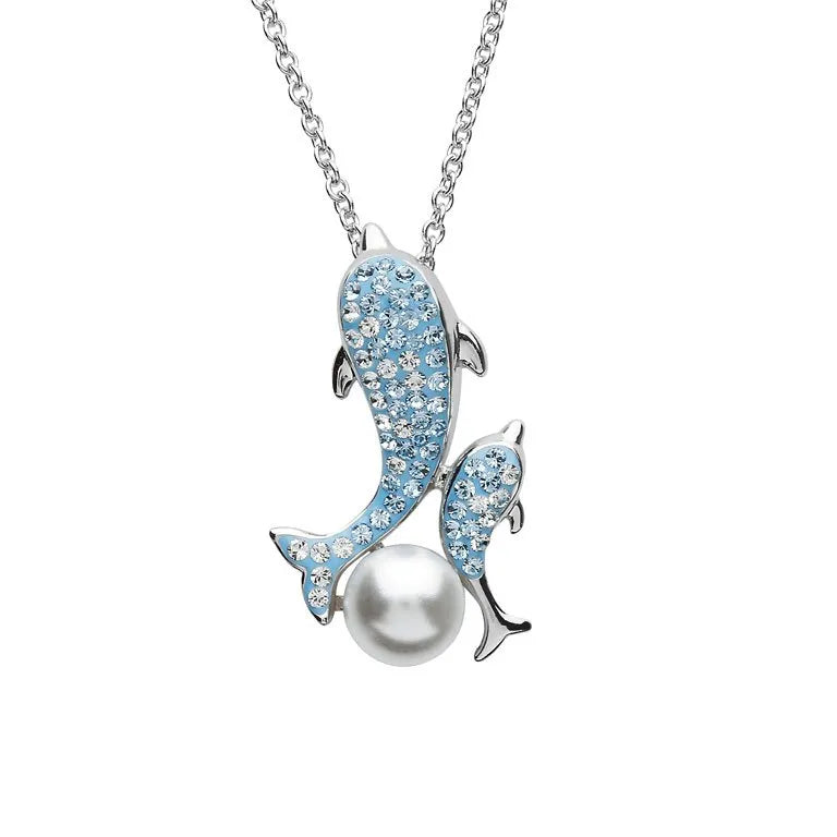 The Shanore Ocean Jewelry features a Swarovski Crystals Dolphin and Baby Pearl Necklace with a silver pendant showcasing two dolphins adorned with light blue crystals. One larger dolphin plays gracefully with a lustrous white pearl on a delicate chain.