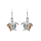 The Shanore Swarovski Crystals Turtle & Baby Dangle Earrings from the Ocean Jewelry collection feature turtle-shaped designs with blue crystal shells and intricate body detailing, all suspended from sterling silver hooks, adding elegance to any ensemble.