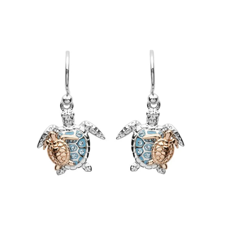The Shanore Swarovski Crystals Turtle & Baby Dangle Earrings from the Ocean Jewelry collection feature turtle-shaped designs with blue crystal shells and intricate body detailing, all suspended from sterling silver hooks, adding elegance to any ensemble.