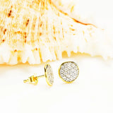 Shanores Gold Vermeil White CZ Stud Earrings from the Ocean Jewelry line glimmer elegantly against a textured seashell backdrop.