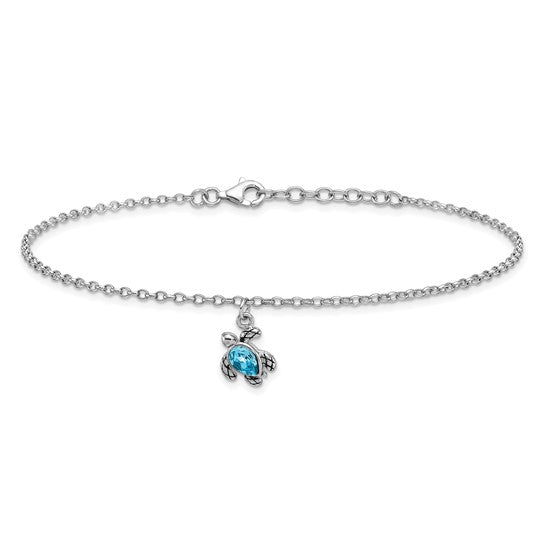 The Presco/Quality Gold Crystal Turtle Dangle Aqua Cry Anklet is a delicate sterling silver piece with a blue crystal turtle charm, shown beautifully on a white background.