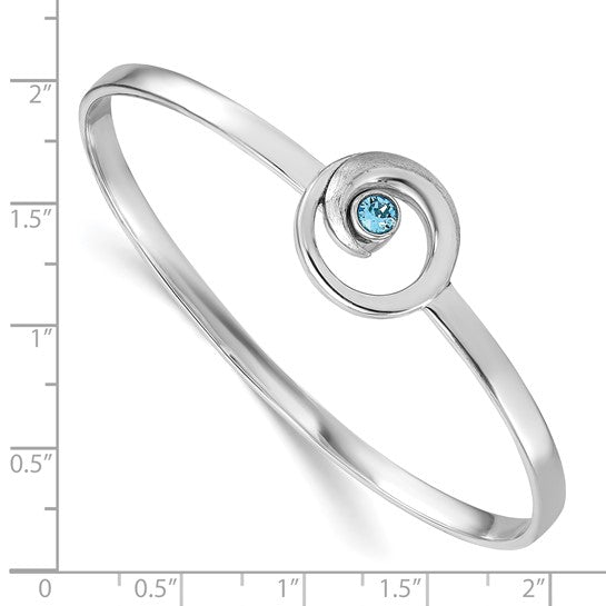 The Presco/Quality Gold Crystal Wave Bangle Bracelet features a sterling silver swirl design with a small blue gemstone and is shown on an inch ruler for size reference.