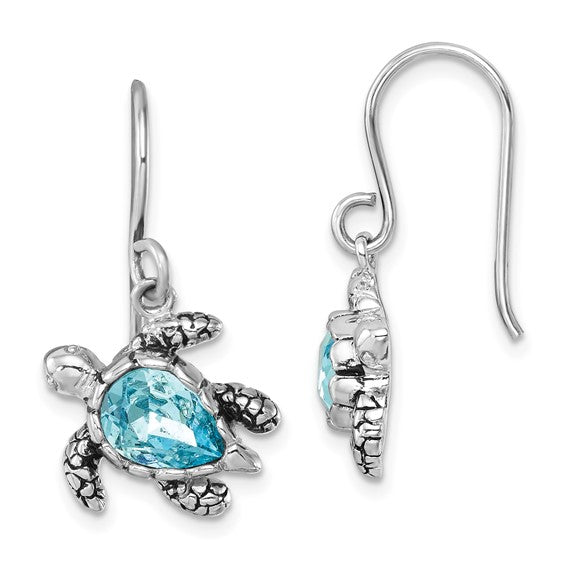 The Presco/Quality Gold Crystal Medium Blue Turtle Earrings feature textured sterling silver and a central blue teardrop gemstone. Shown are front and side views of this elegant jewelry pair.