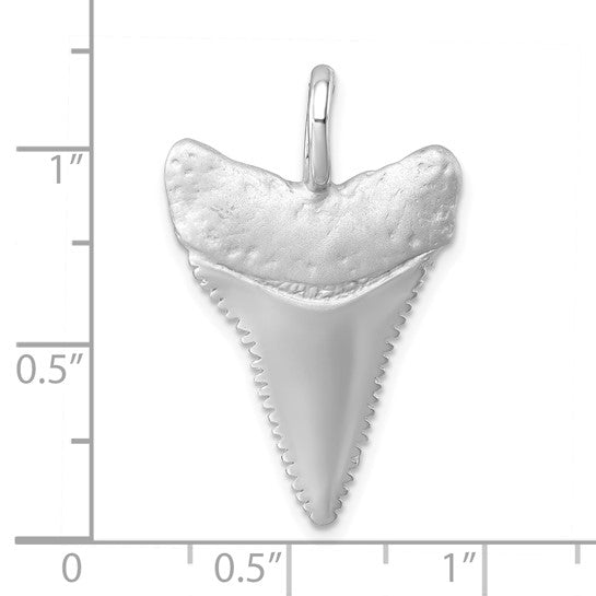 The Presco/Quality Gold Sterling Silver Brushed Great White Shark Tooth Pendant features a textured finish and serrated edges, shown on a white grid with inch markers to highlight its size—just over 1 tall and about 0.75 wide.