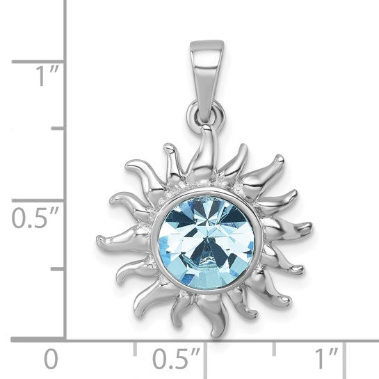 The Presco/Quality Gold Crystal Sun with Aqua Crystal Pendant features a sun-shaped sterling silver design with wavy rays and a round aqua crystal at the center, shown against an inch-marked grid for size.