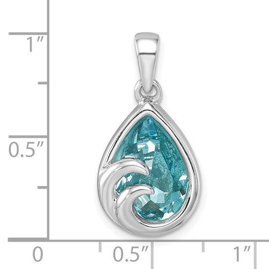 The Presco/Quality Gold Crystal Wave Tear Drop Pendant features a blue gemstone and sterling silver wave design, displayed on a grid with inch markings for size reference.