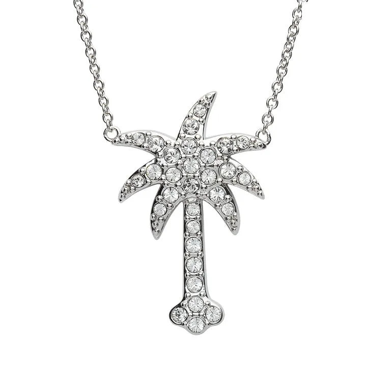 The Shanore Swarovski Crystals White Palm Tree Necklace-Ocean Jewelry features a sterling silver palm tree, sparkling with Swarovski crystals, elegantly centered on a delicate chain against a white background.