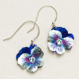 Introducing the Bonnie Blue Garden Pansy Drop Earrings by Holly Yashi: elegant niobium dangling earrings featuring pansy designs in blue, silver, and purple. Each hypo-allergenic silver hook sports a sparkling central stone set against an off-white backdrop for timeless charm.